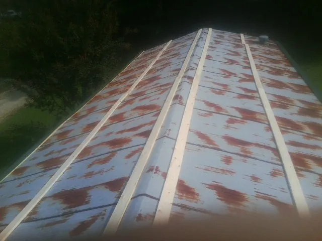 Rusted metal roof panels with new wood purlins before replacement — Storm Damage Roof Repair in Rossiter by Roofing Brothers